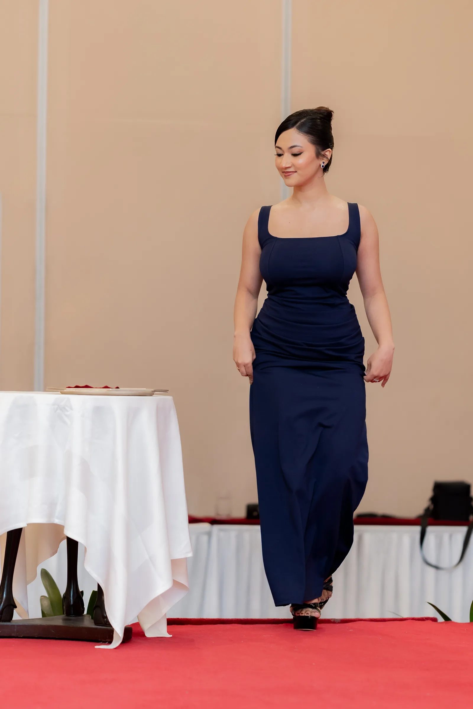 Shristi Bhusal walking the red carpet in a navy dress at Miss Universe Nepal 2026